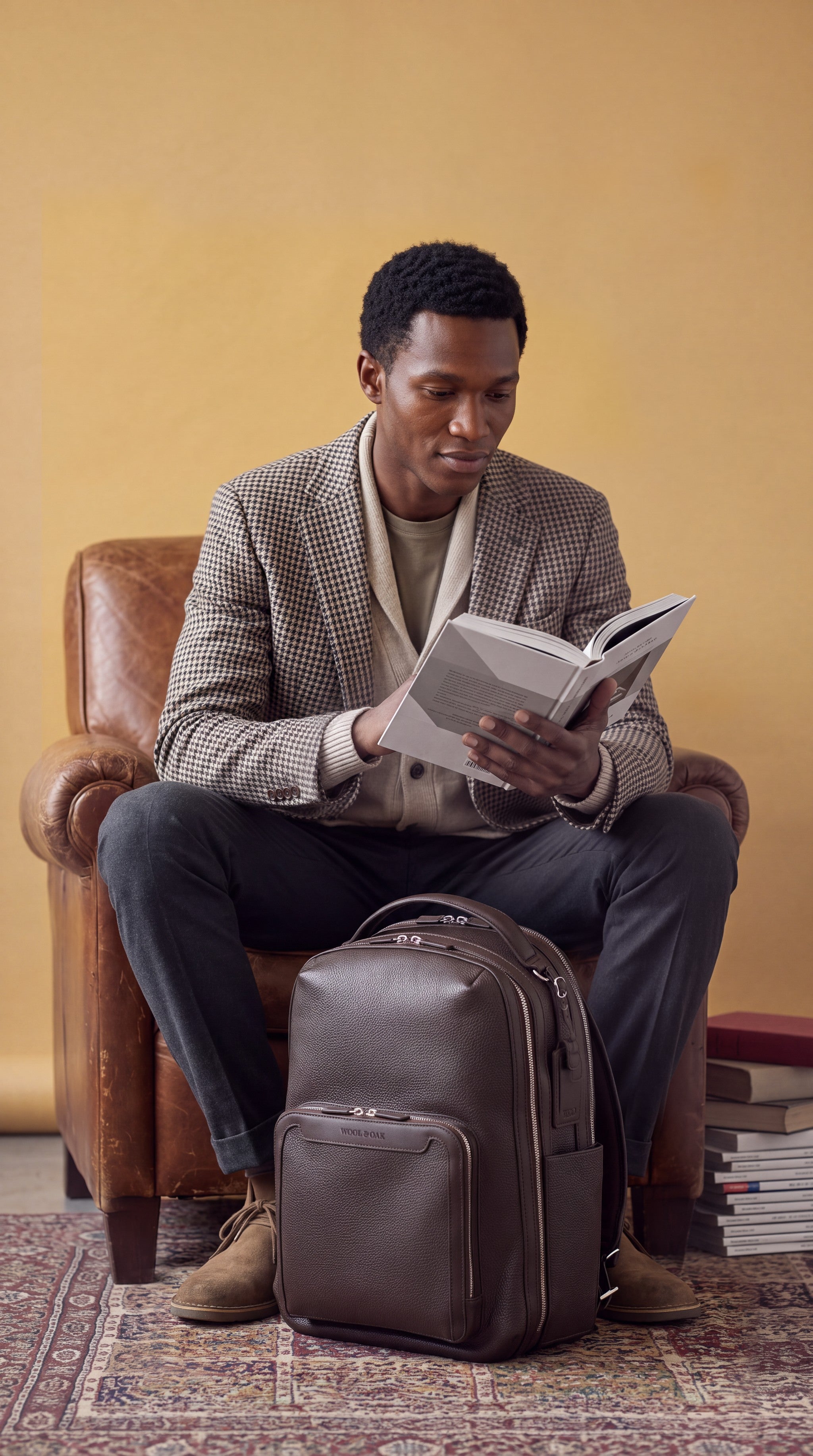 Pilot Travel Backpack reading in a vintage armchair | #Color_Chocolate