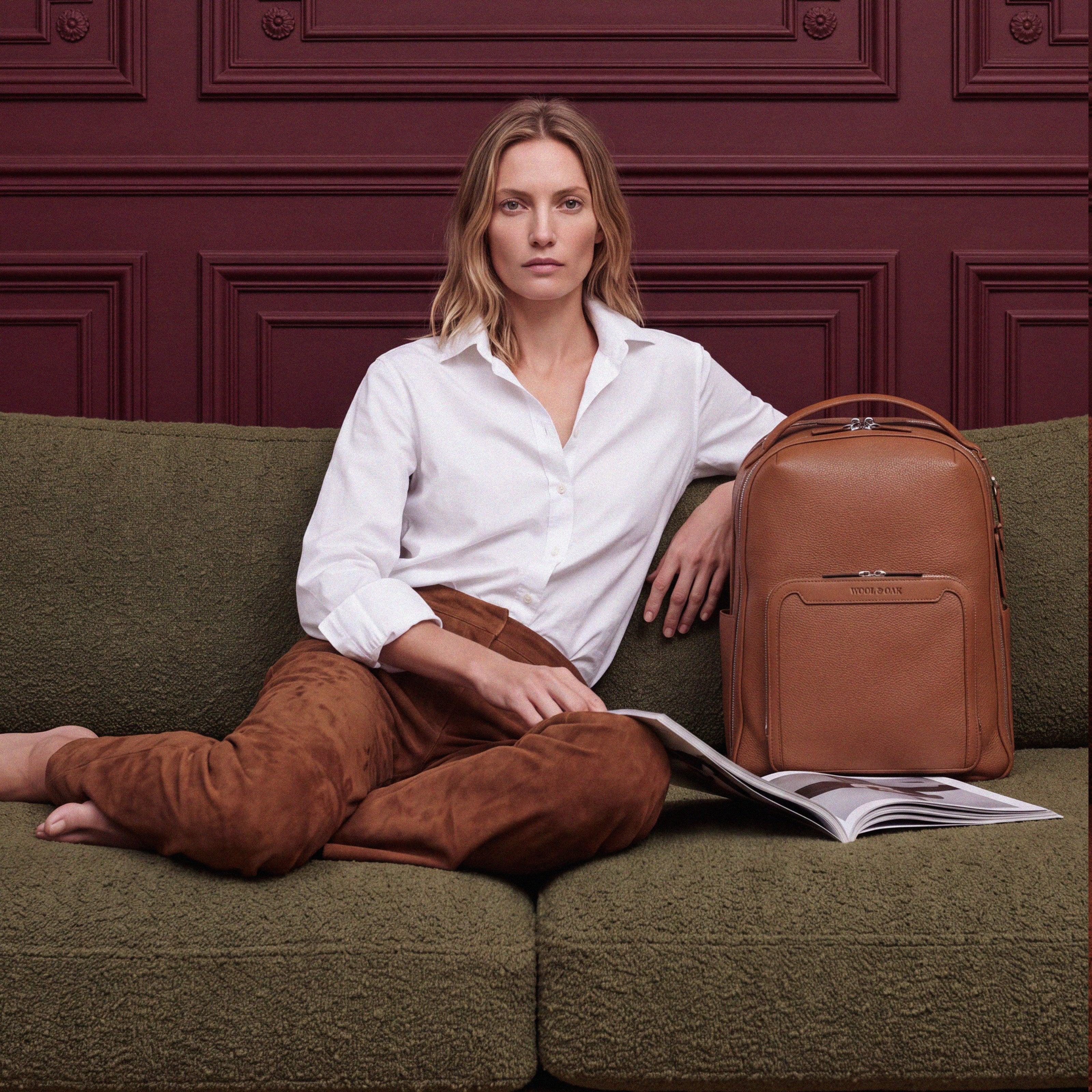 Pilot Travel Backpack beside a woman on a sofa| #color_Sand