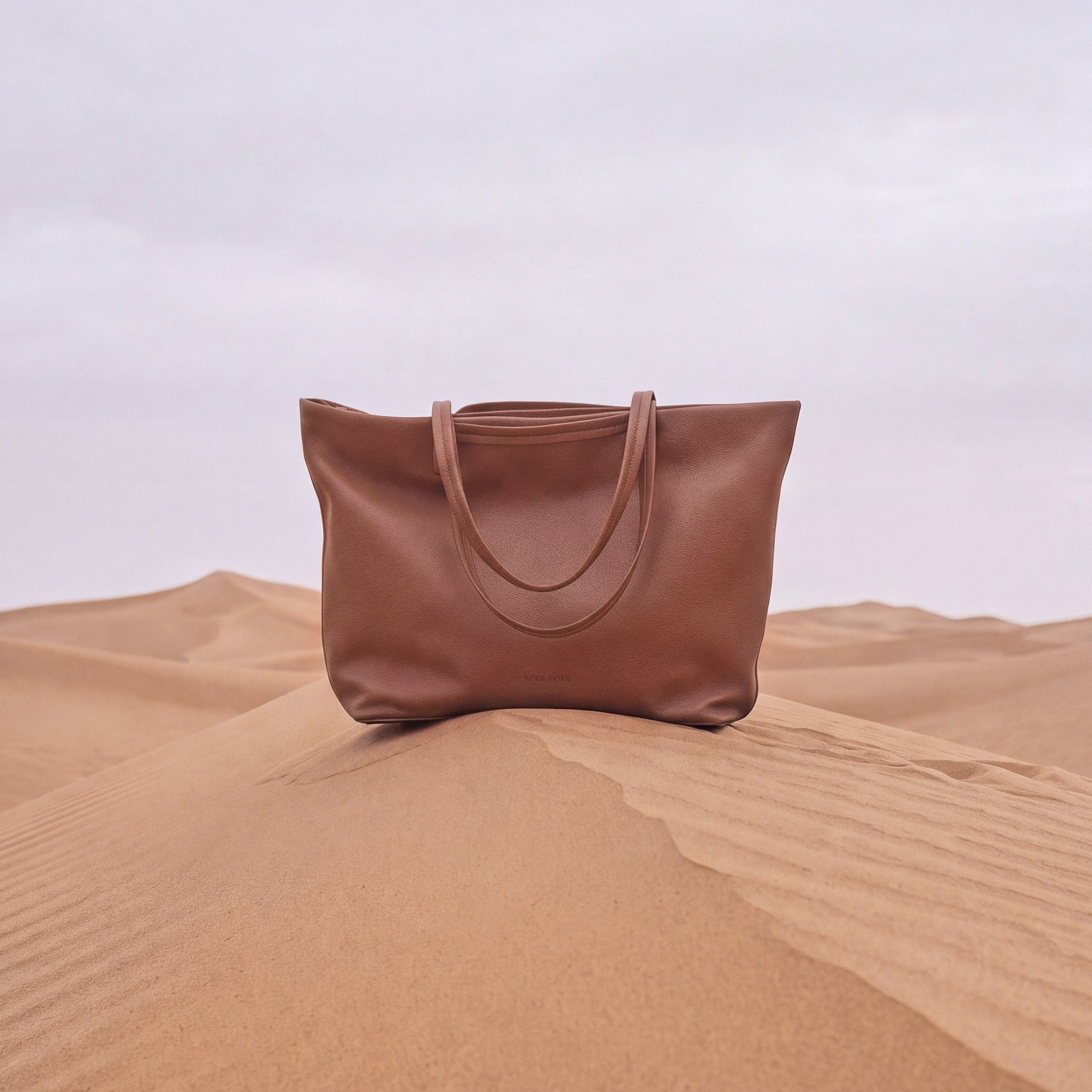Rove Travel Tote on a desert dune| #color_Sand